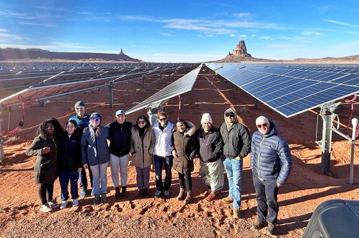 grad students standing in front of solar panels