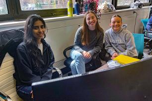 Graduate student Harman and undergraduates Laura and Maria work together at a computer