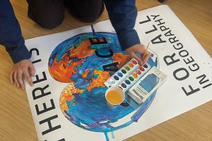student painting a map