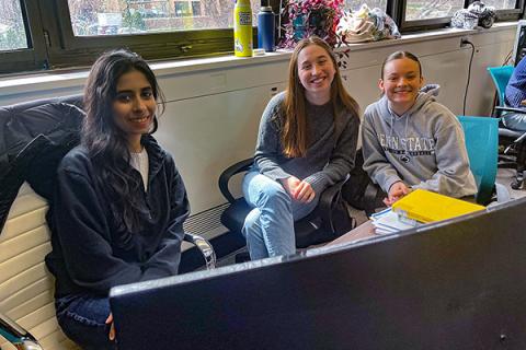 Graduate student Harman and undergraduates Laura and Maria work together at a computer