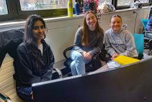 Graduate student Harman and undergraduates Laura and Maria work together at a computer