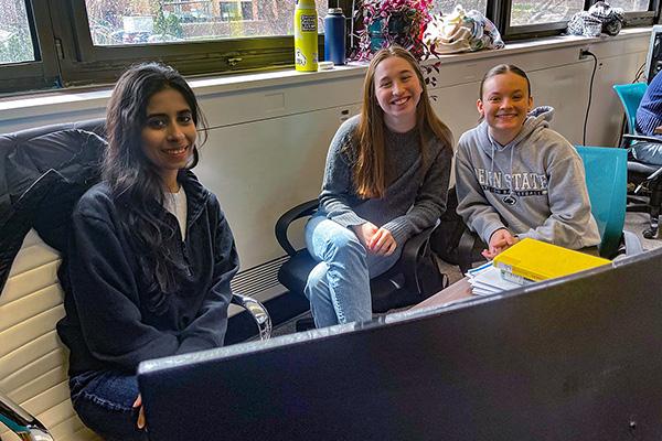 Graduate student Harman and undergraduates Laura and Maria work together at a computer