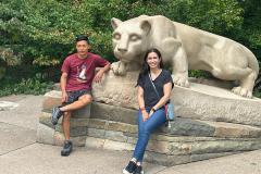 Photo of Belen and Geovanni in front of Nittany Lion Shrine