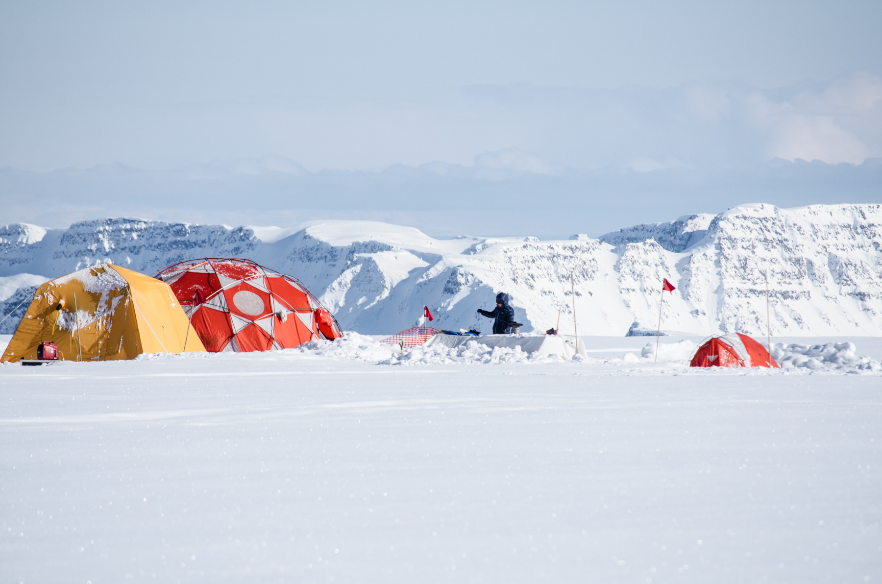 Luke Trusel configures equipment to measure sub-surface temperatures in the West Greenland ice cap.  Image: Sarah Das ©Woods Hol